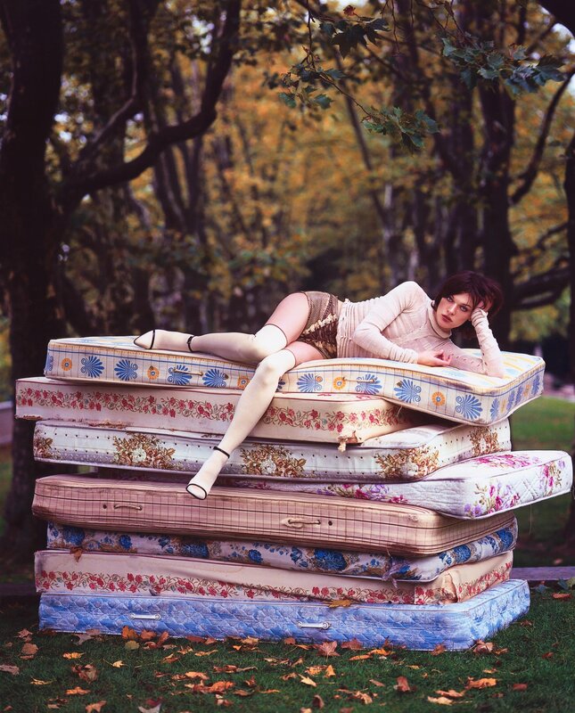 woman on stacked mattresses