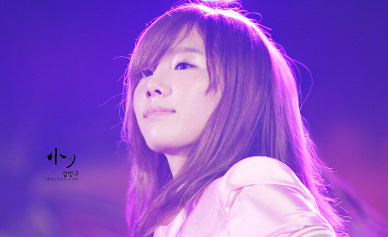 woman on stage under purple light