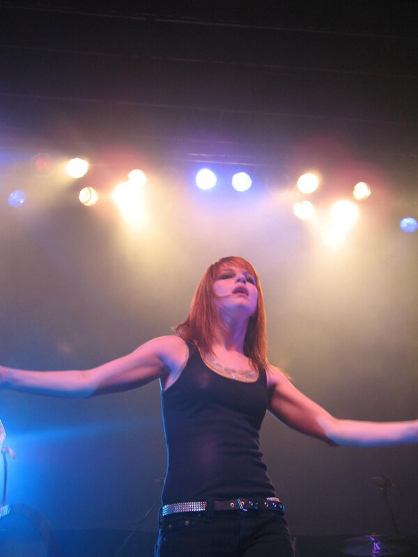 Woman on Stage with Arms Outstretched