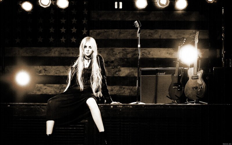 Woman on stage with guitars