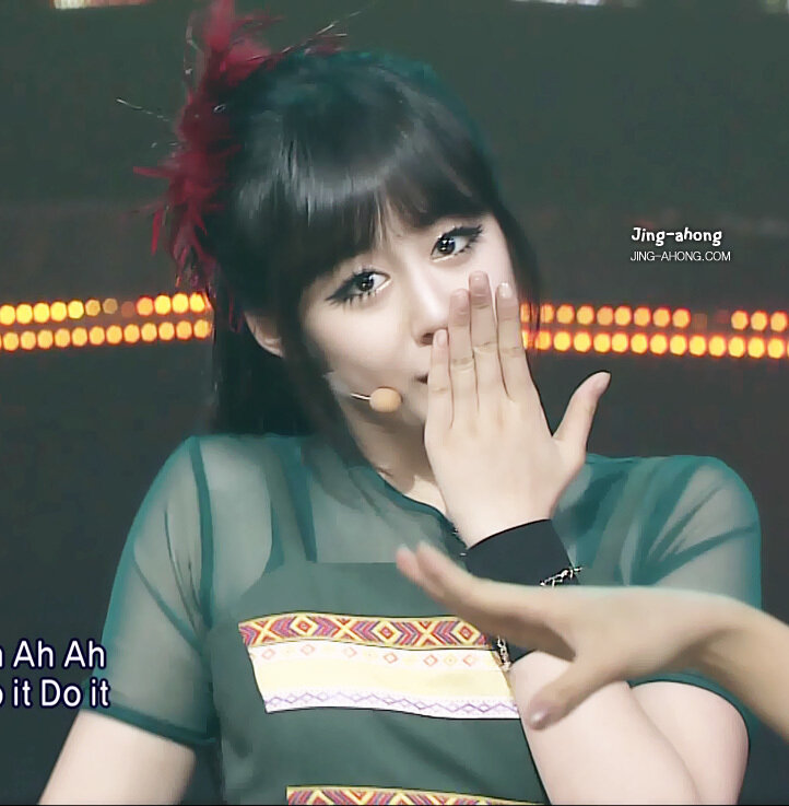 woman on stage with hand gesture