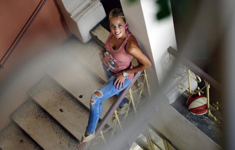 Woman on staircase with basketball