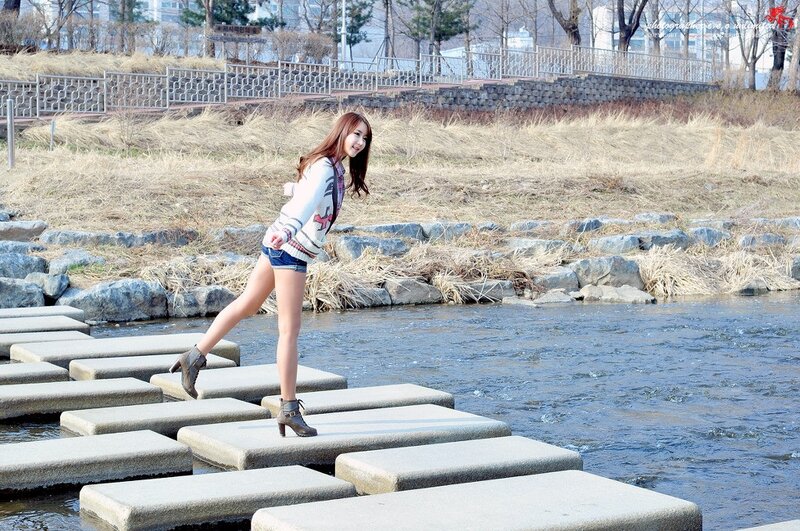 Woman on stepping stones by river