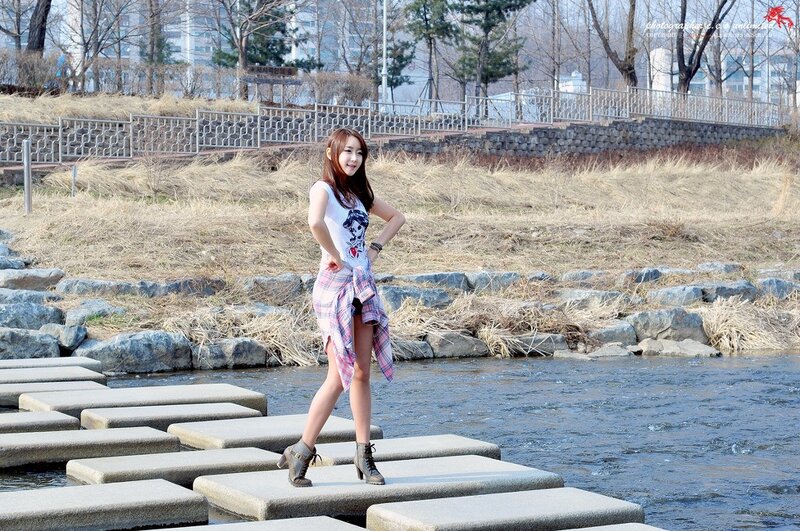 Woman on stepping stones by river