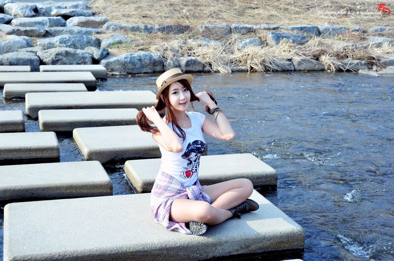 Woman on stepping stones by river