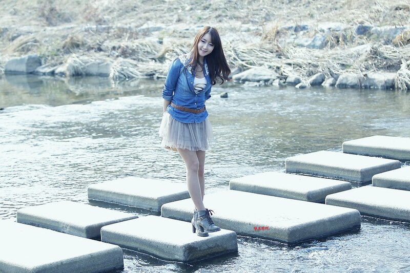 Woman on stepping stones by river