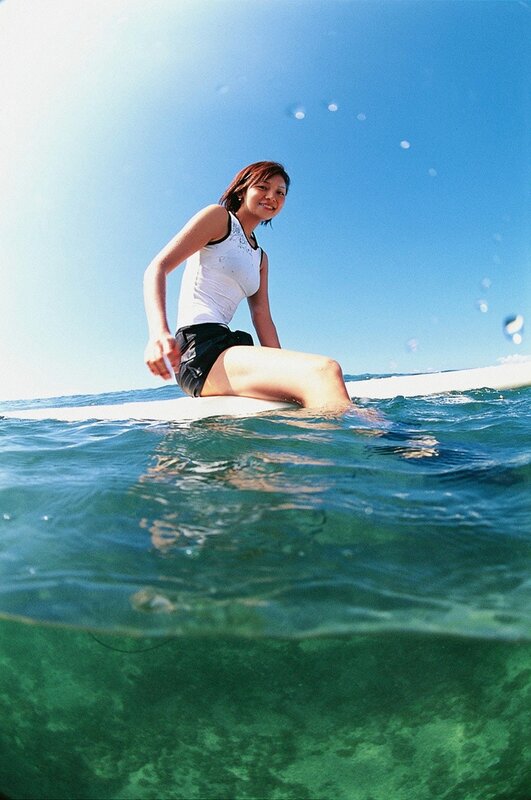 Woman on surfboard in ocean