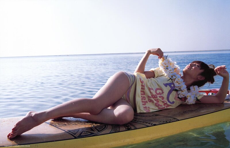 Woman on surfboard with lei