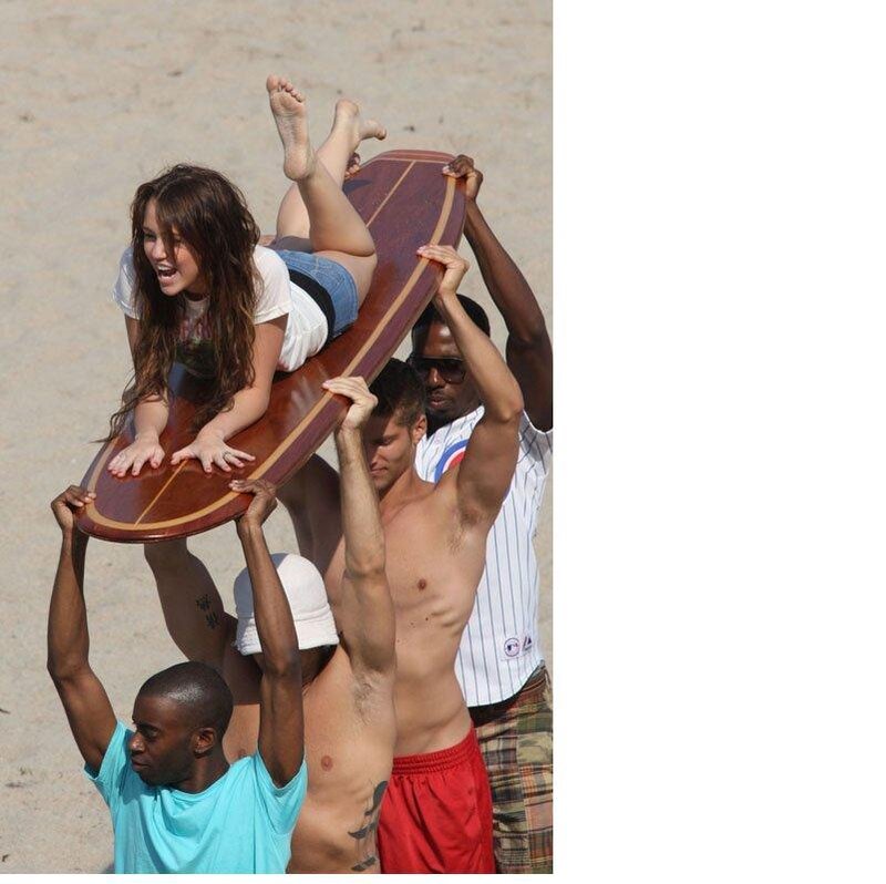 woman on surfboard with men