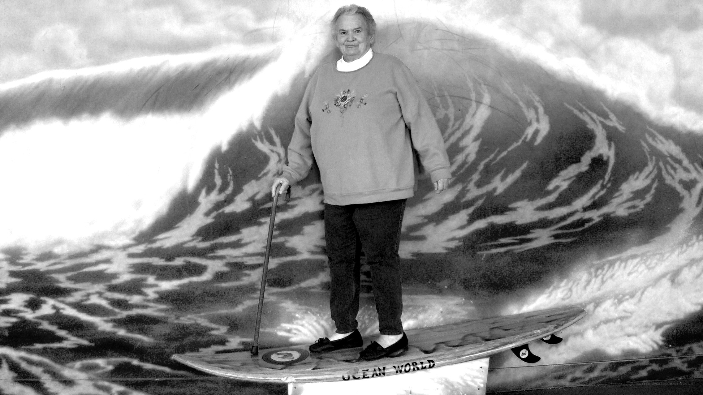Woman on surfboard with wave backdrop