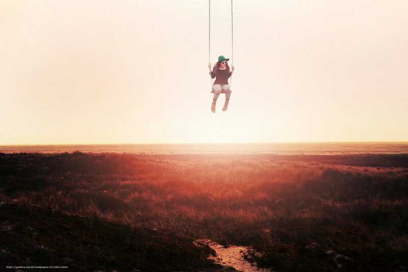 Woman on swing at sunset