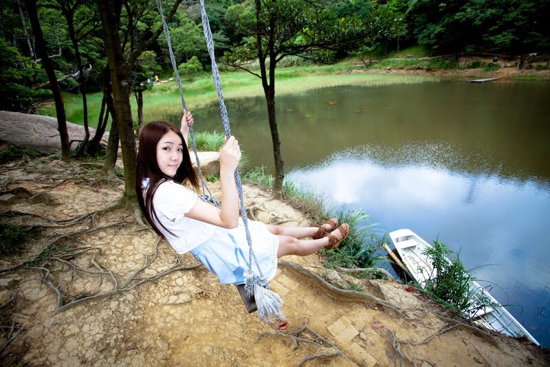 Woman on swing by lake