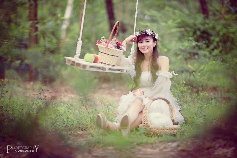 Woman on swing in forest