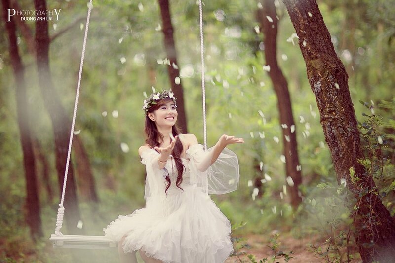 Woman on swing in forest