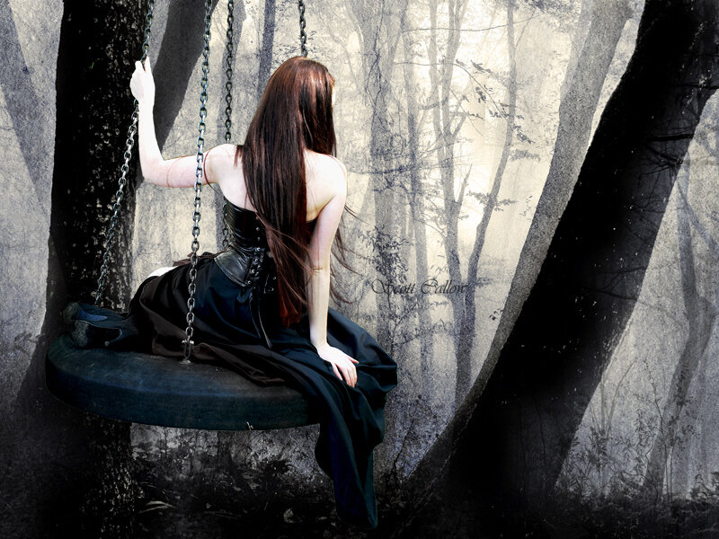 woman on swing in forest