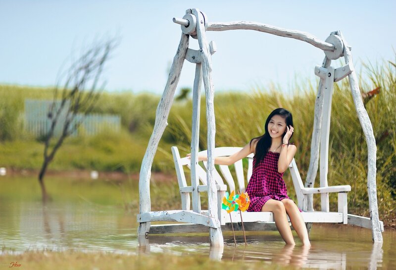 Woman on swing in water