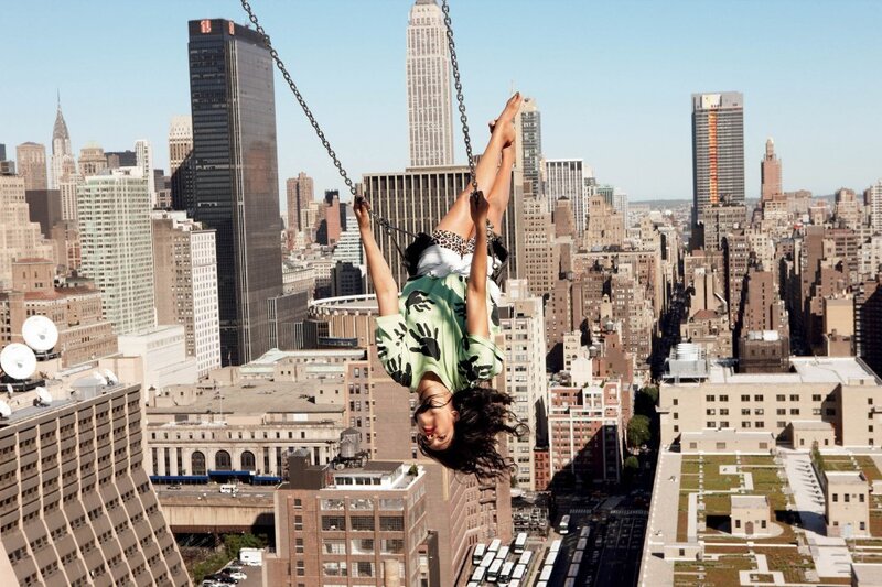 Woman on swing over city