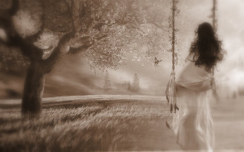 woman on swing under tree