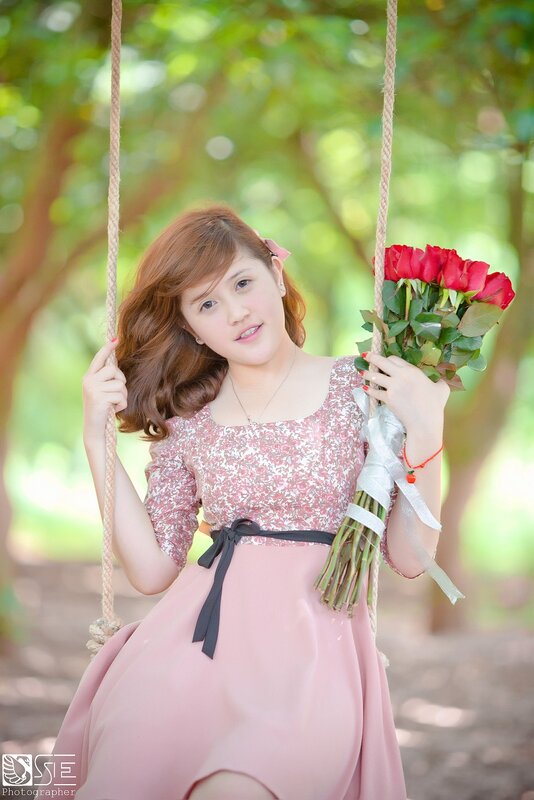 Woman on swing with roses