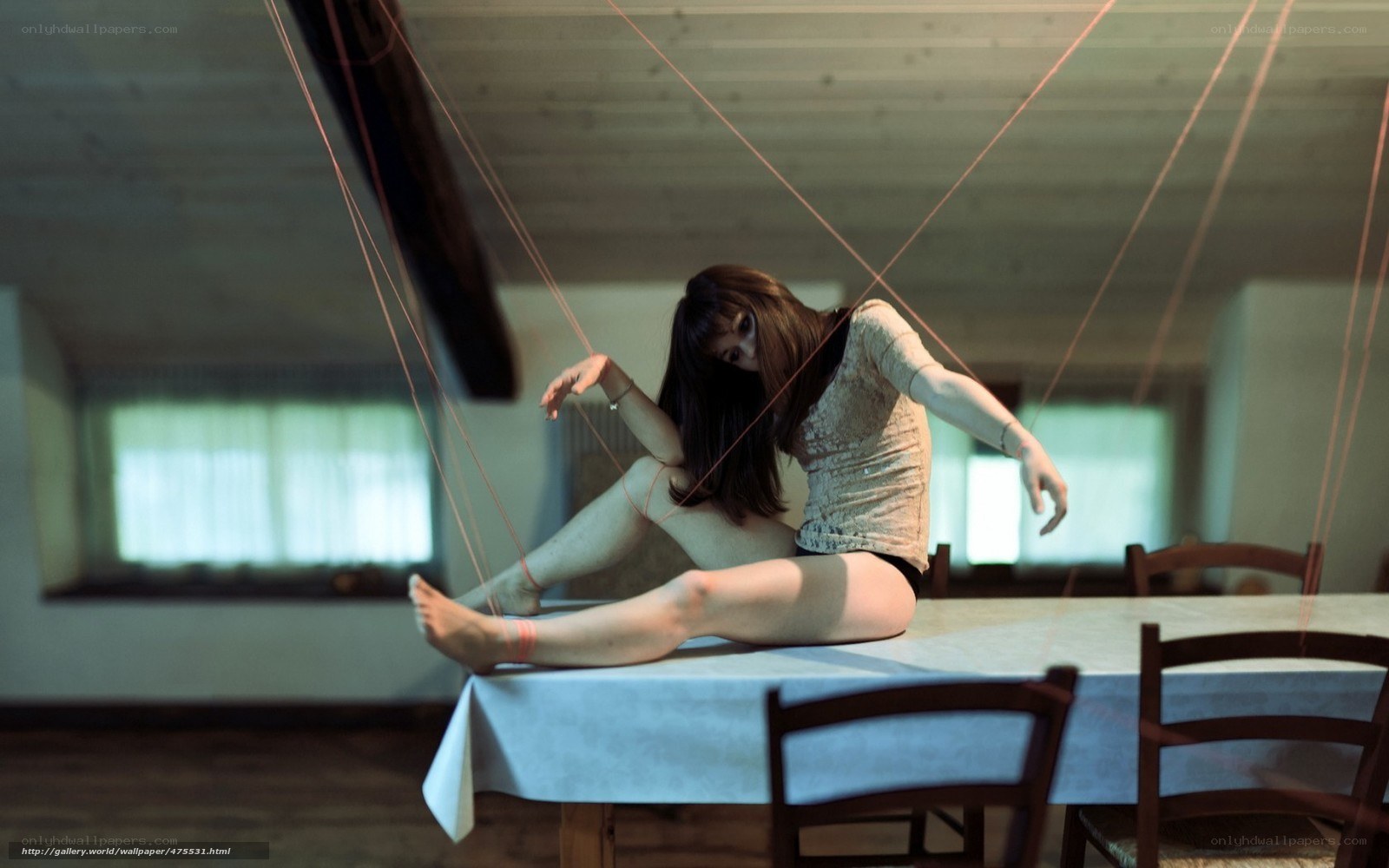 woman on table with strings