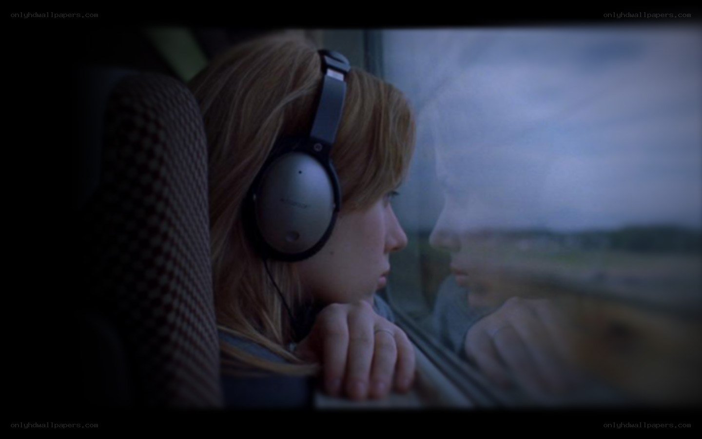 woman on train looking out window