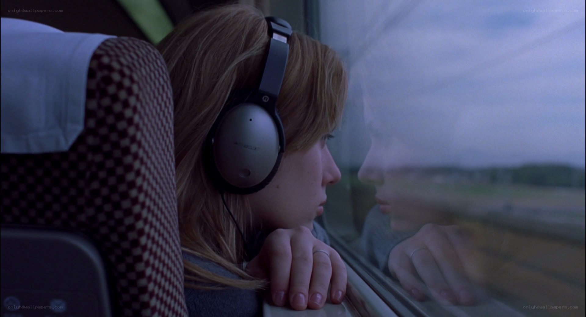 woman on train looking out window