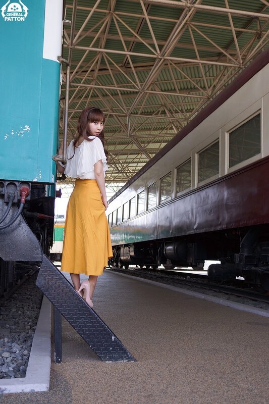 Woman on Train Platform — Yellow