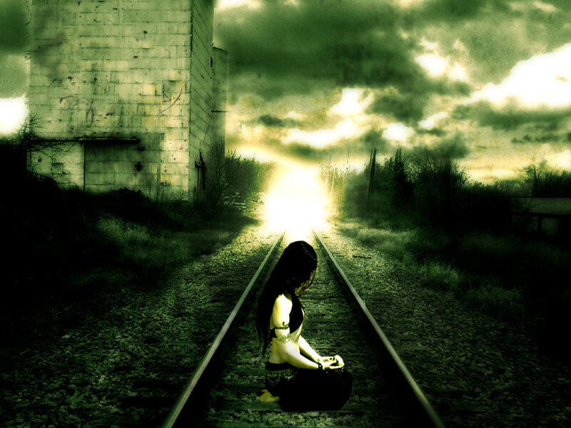 woman on train tracks at sunset