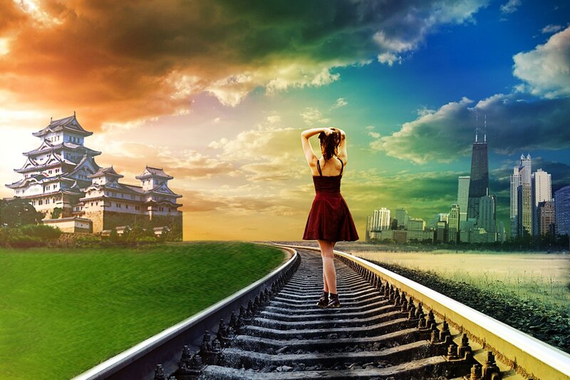Woman on train tracks between castle and city