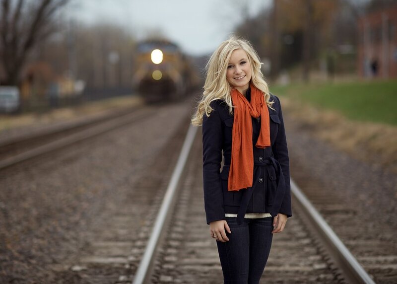 Woman on train tracks with train