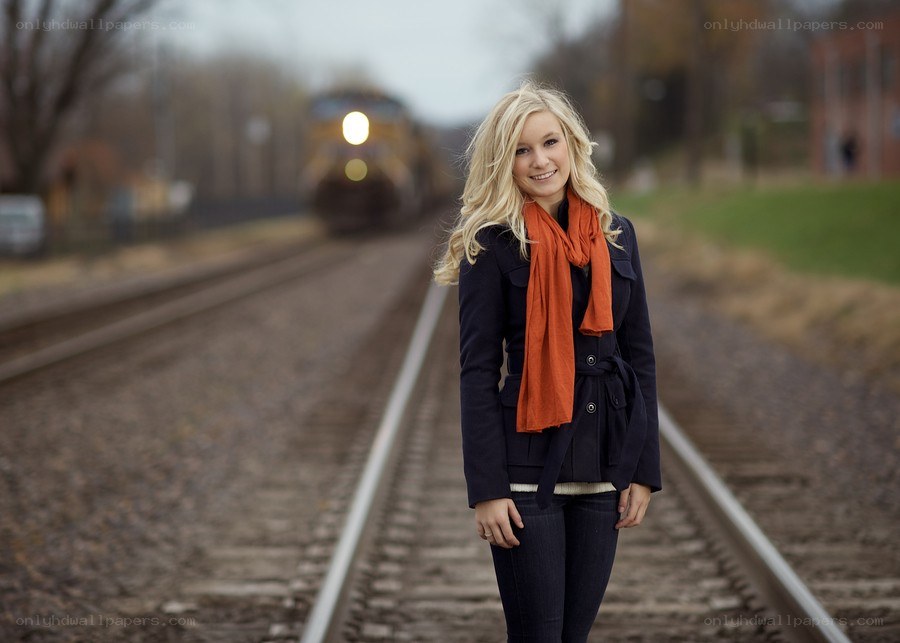 Woman on train tracks with train