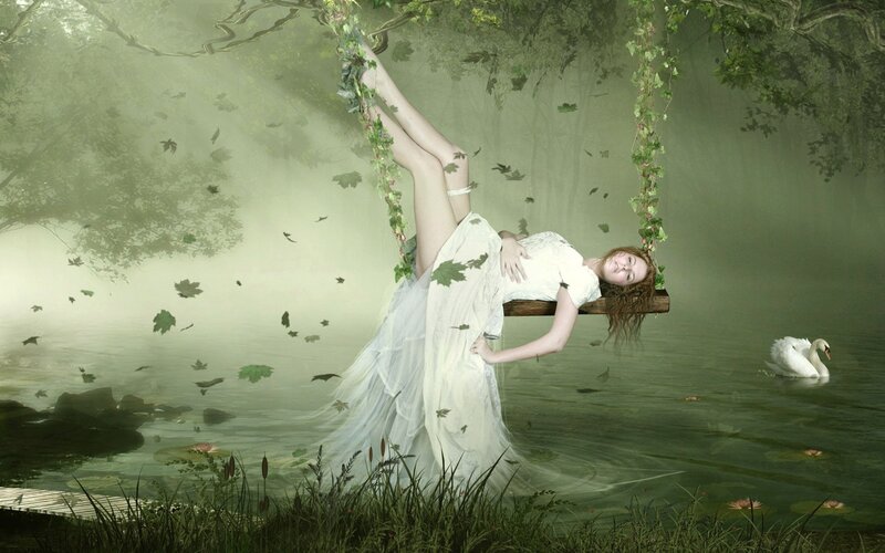 woman on vine swing in forest