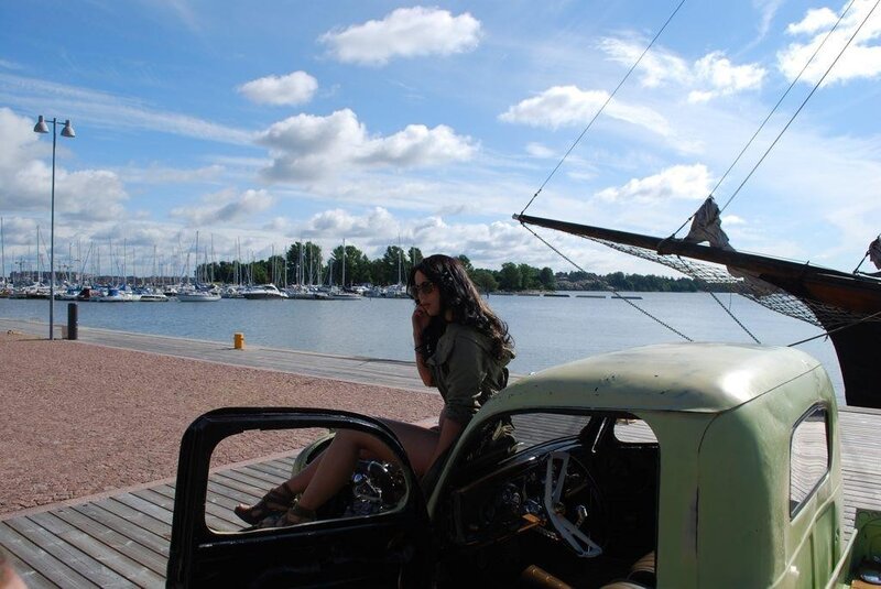 Woman on vintage truck by marina