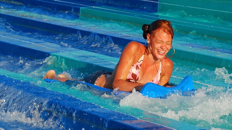 Woman on water slide at park