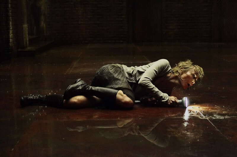 Woman on wet floor with flashlight