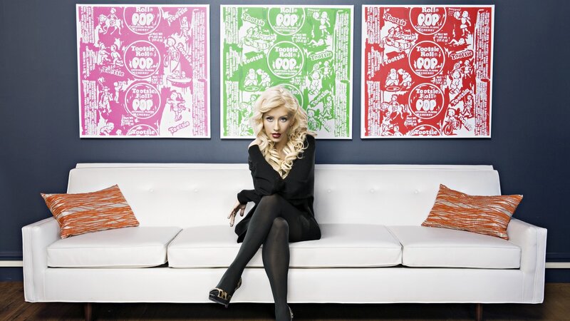 Woman on white couch with art