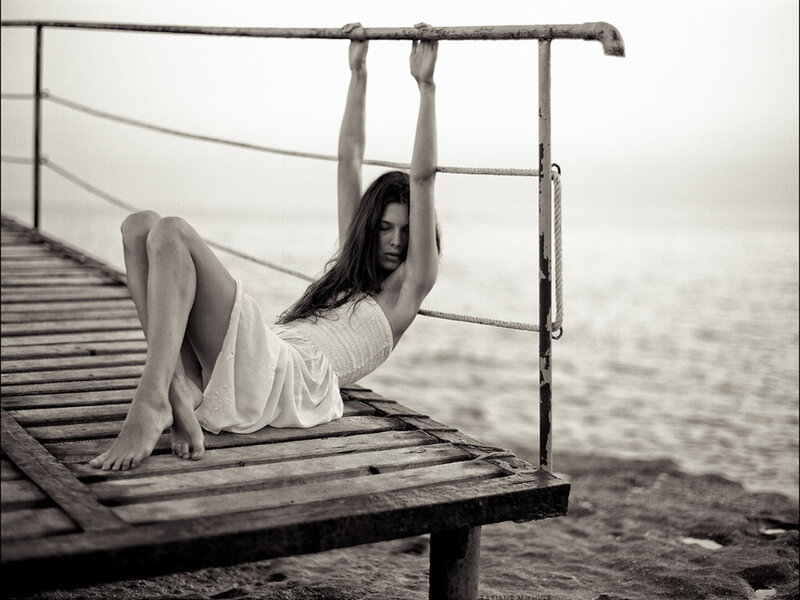 Woman on Wooden Dock — Black, Serene, Photograph