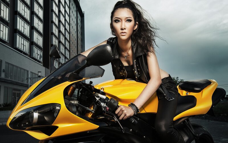 woman on yellow motorcycle