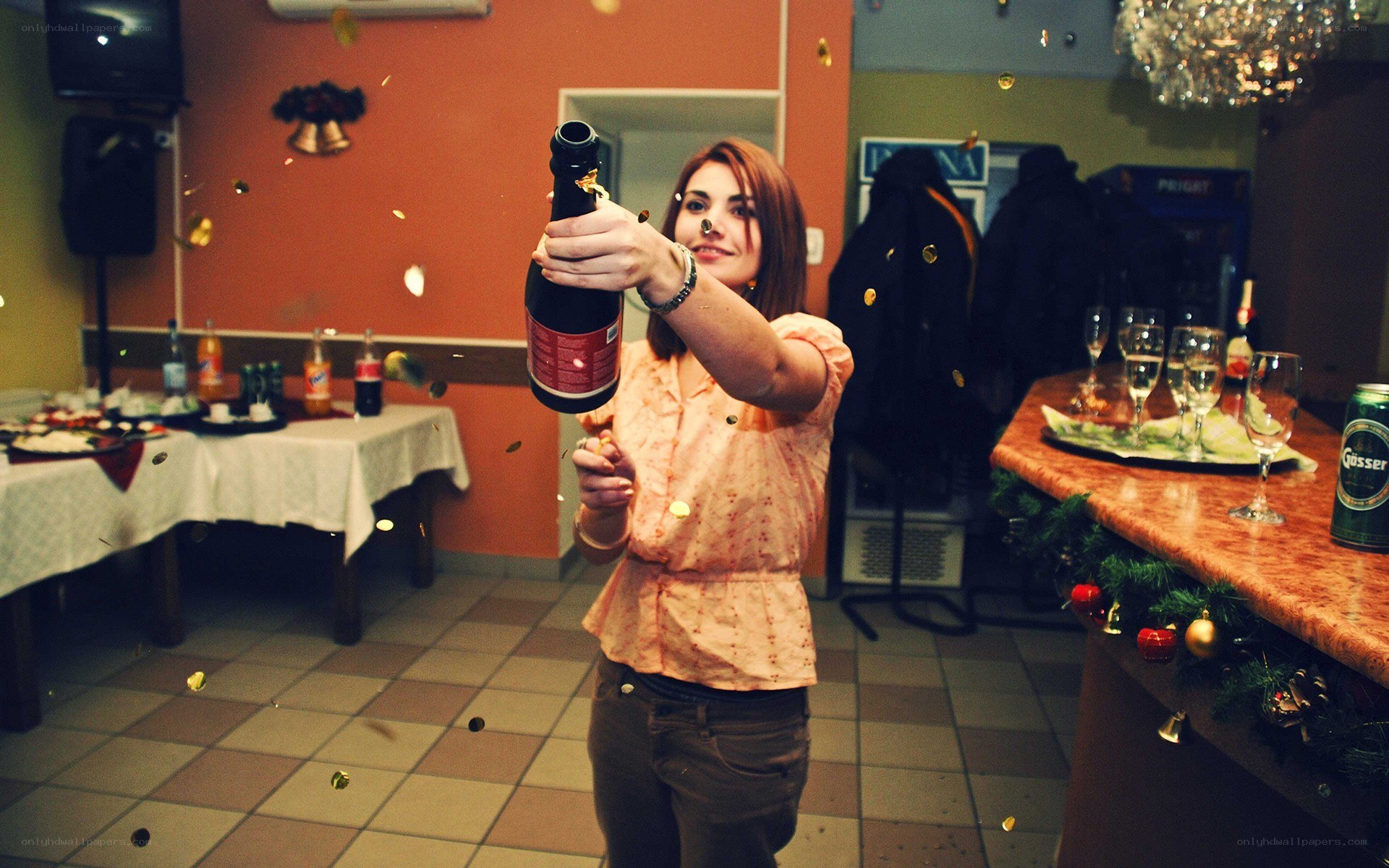 Woman opening champagne bottle