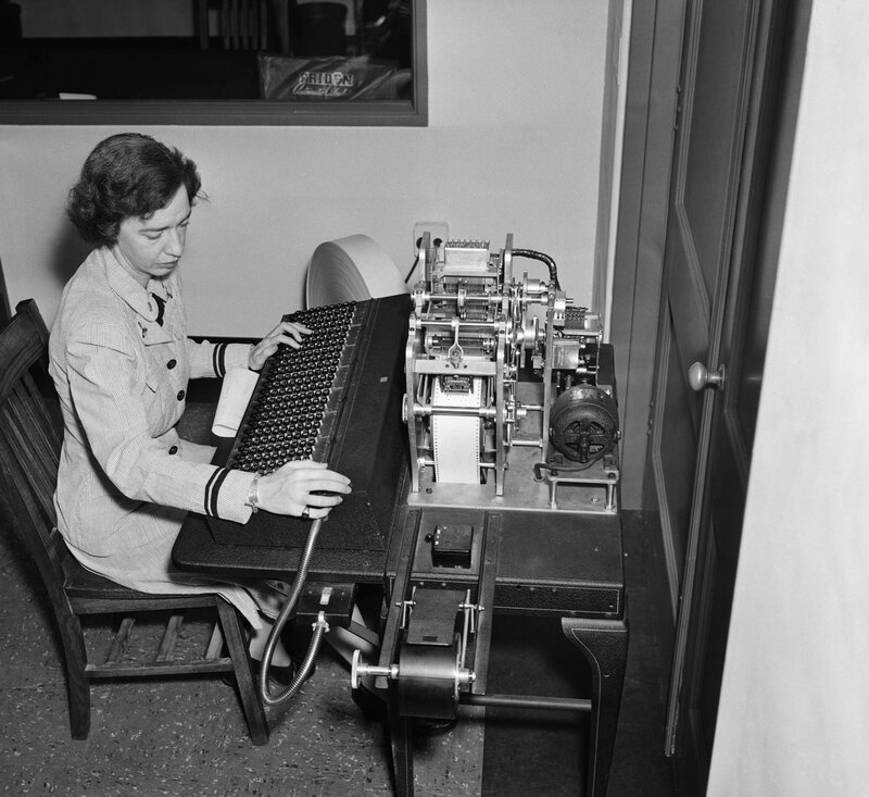 Woman operating a teleprinter machine
