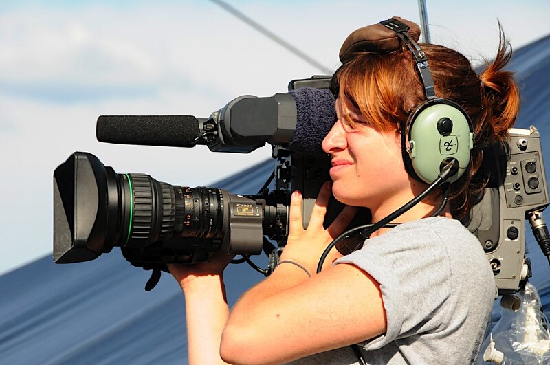 Woman operating video camera