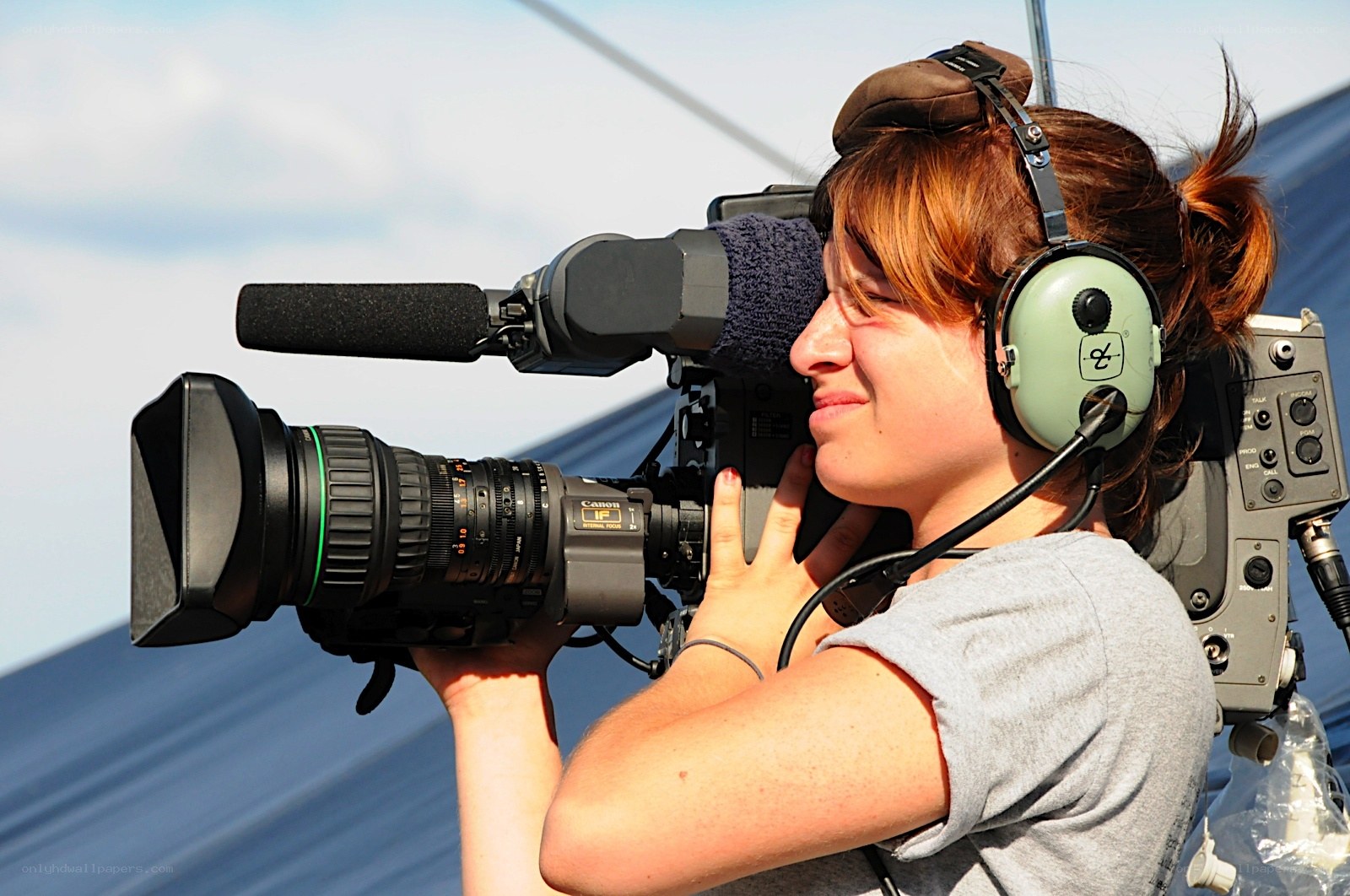 Woman operating video camera