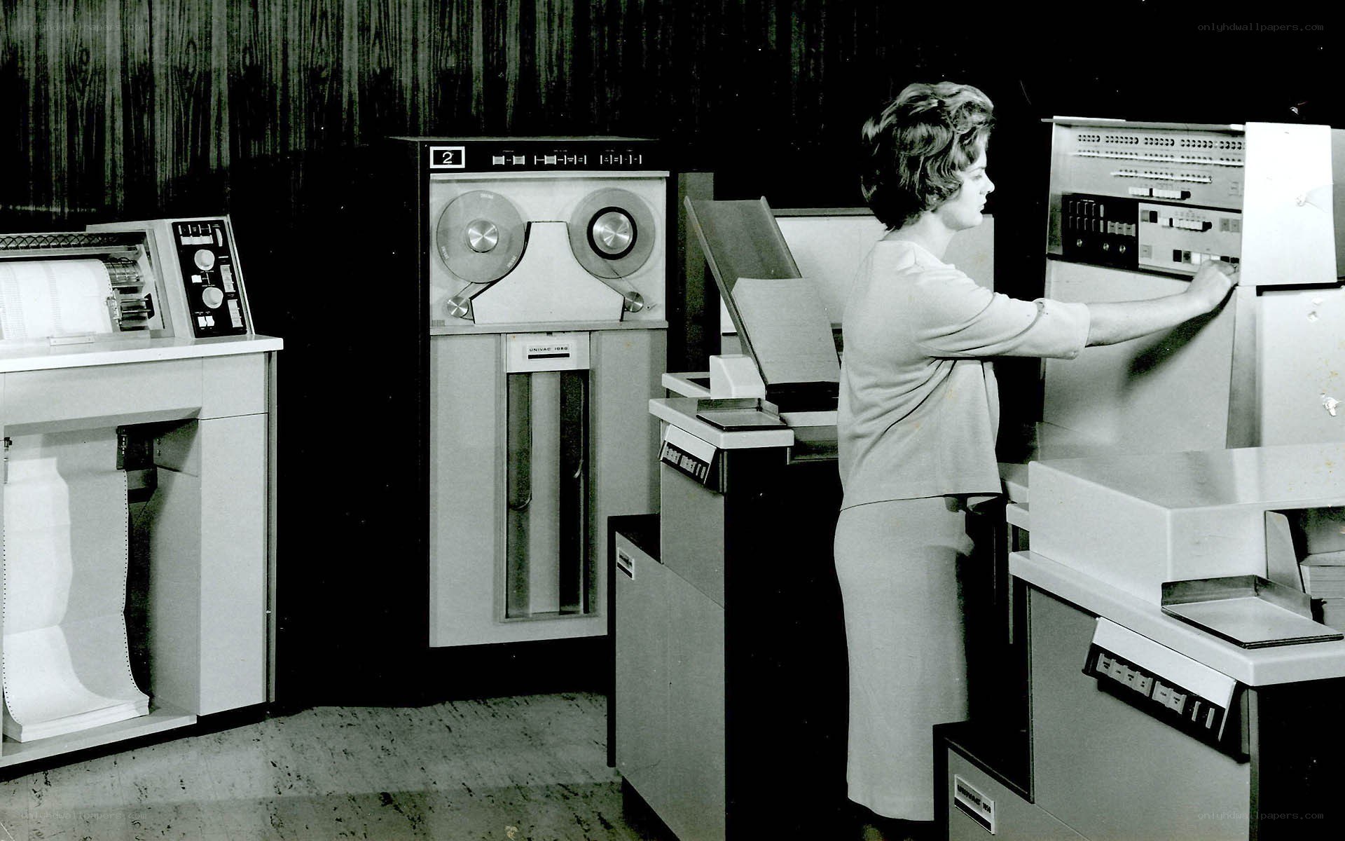 Woman operating vintage computer equipment
