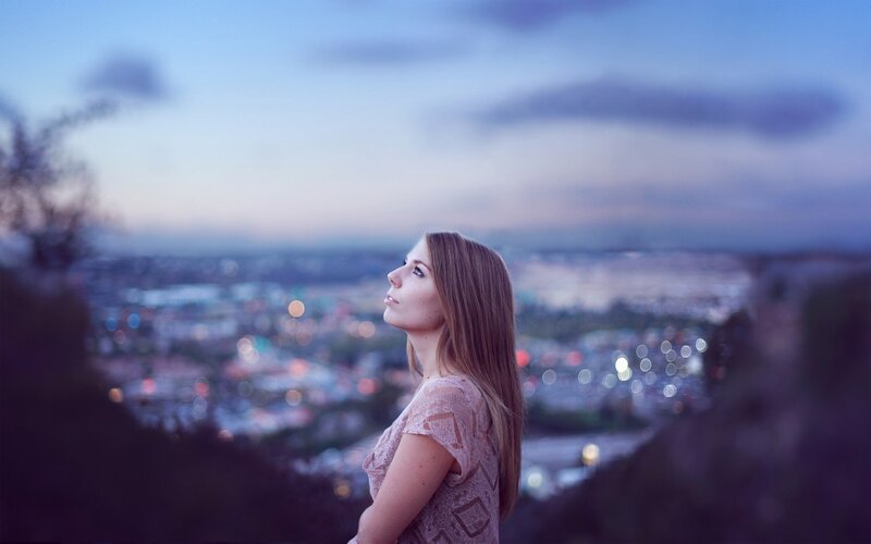 woman overlooking city at dusk
