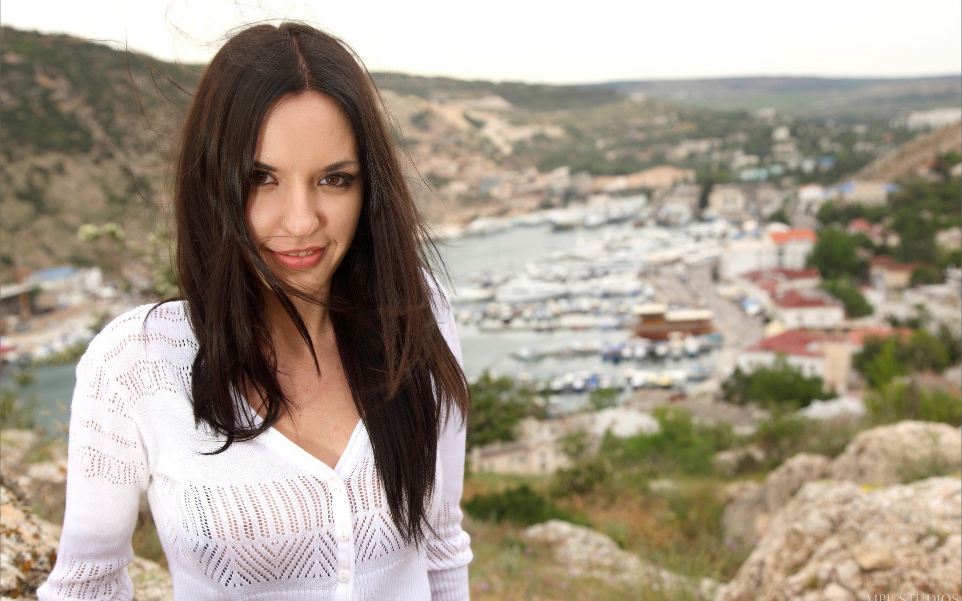 woman overlooking coastal town
