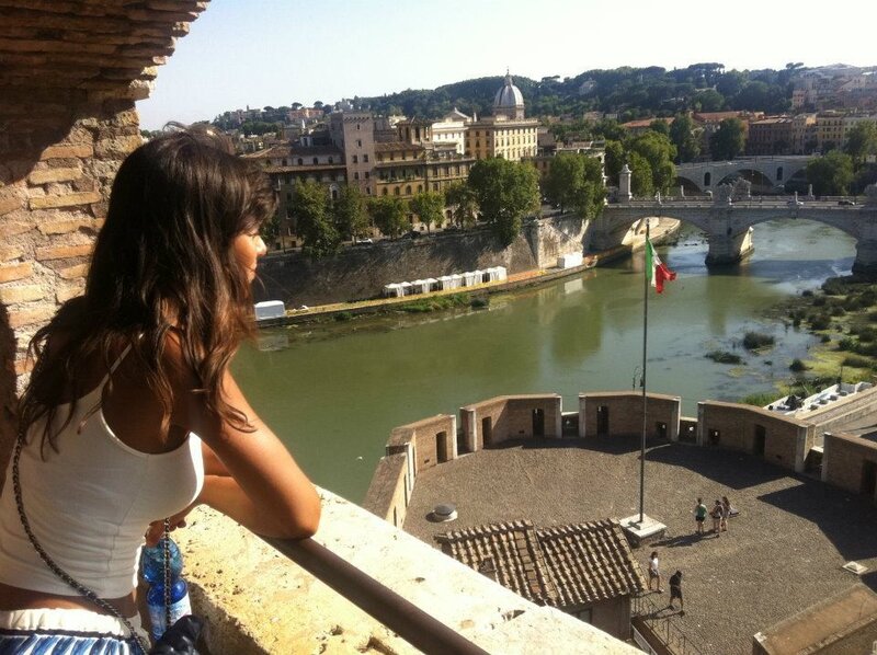 Woman overlooking Rome from a castle
