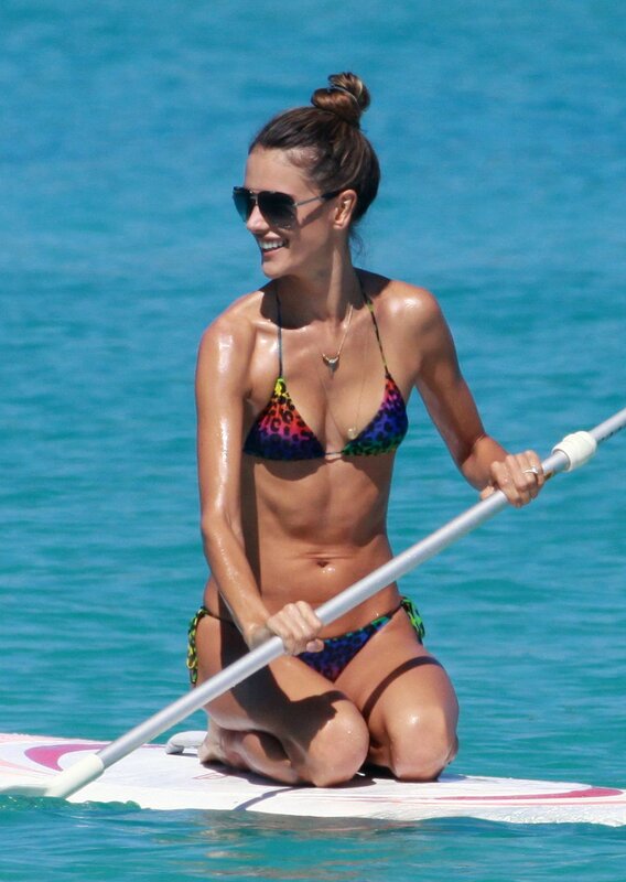 woman paddleboarding in bikini