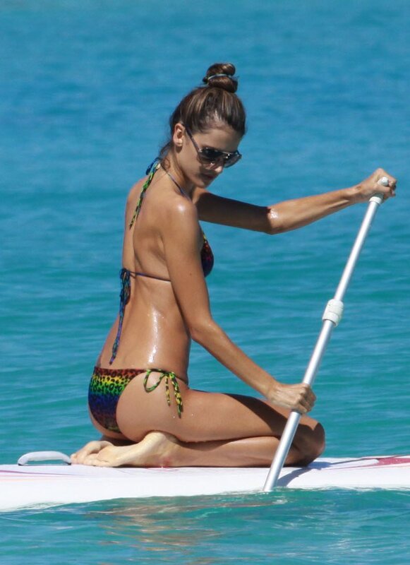 woman paddleboarding in bikini