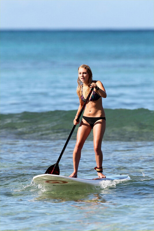 Woman paddleboarding in ocean