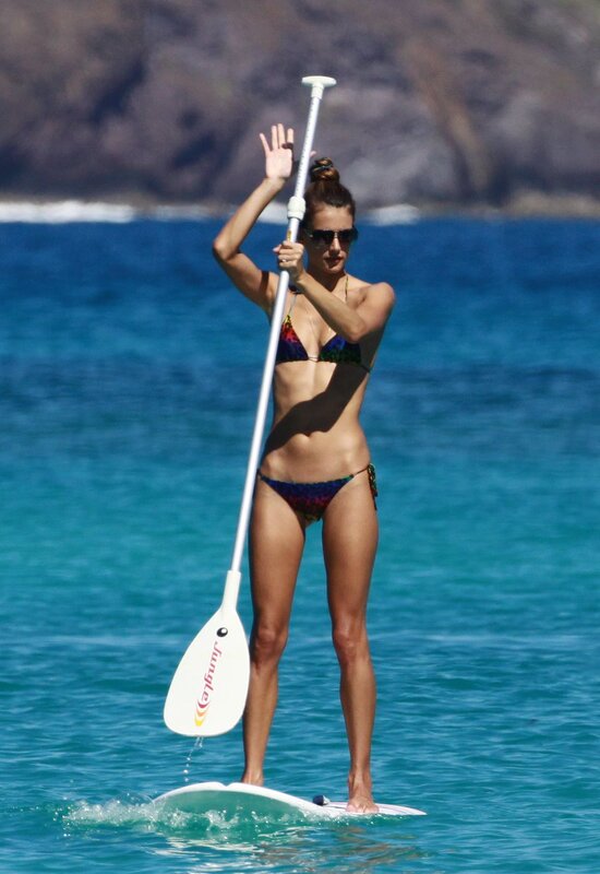 Woman paddleboarding in ocean